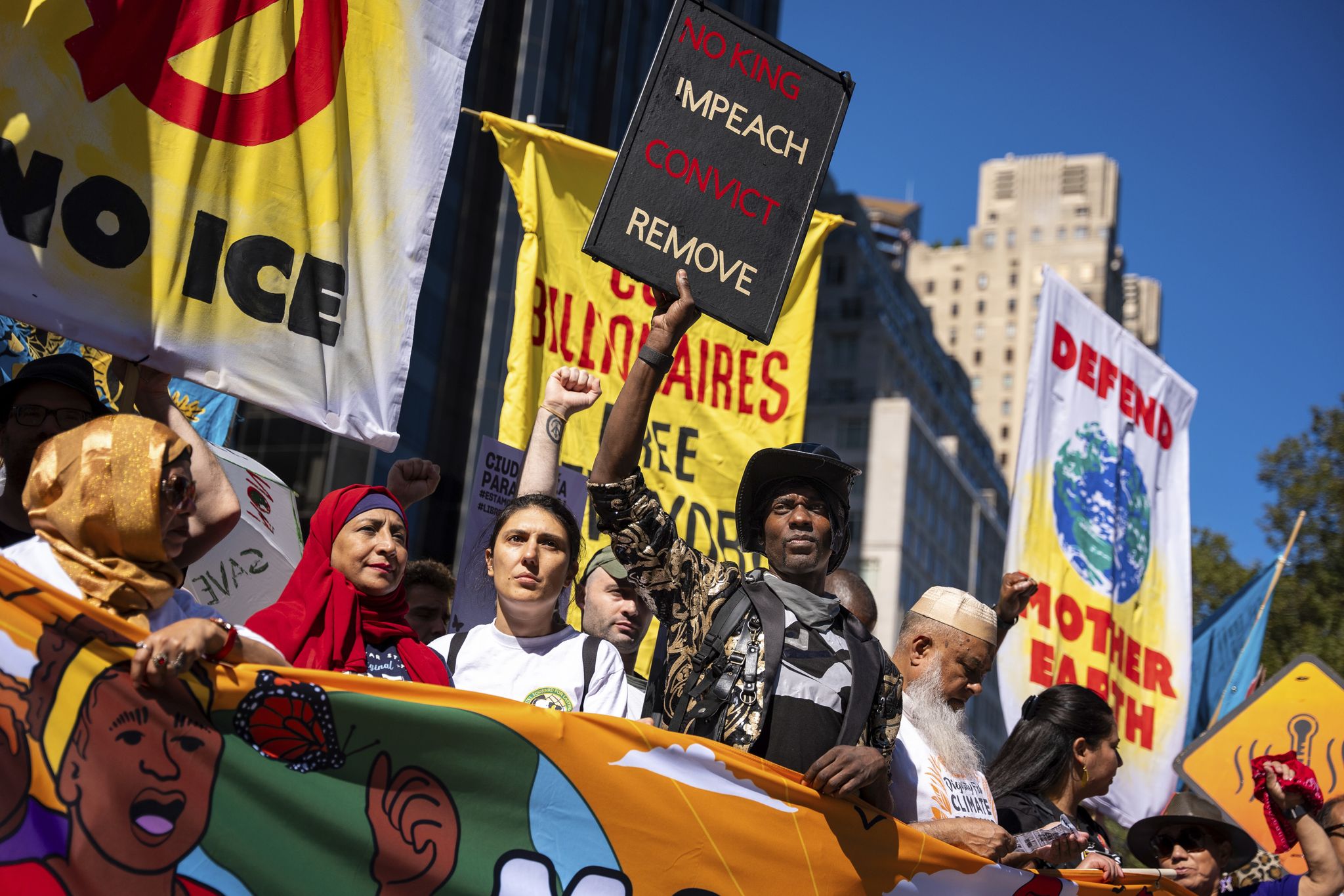 Photos show activists targeting billionaires in a street protest on the eve of New York Climate Week